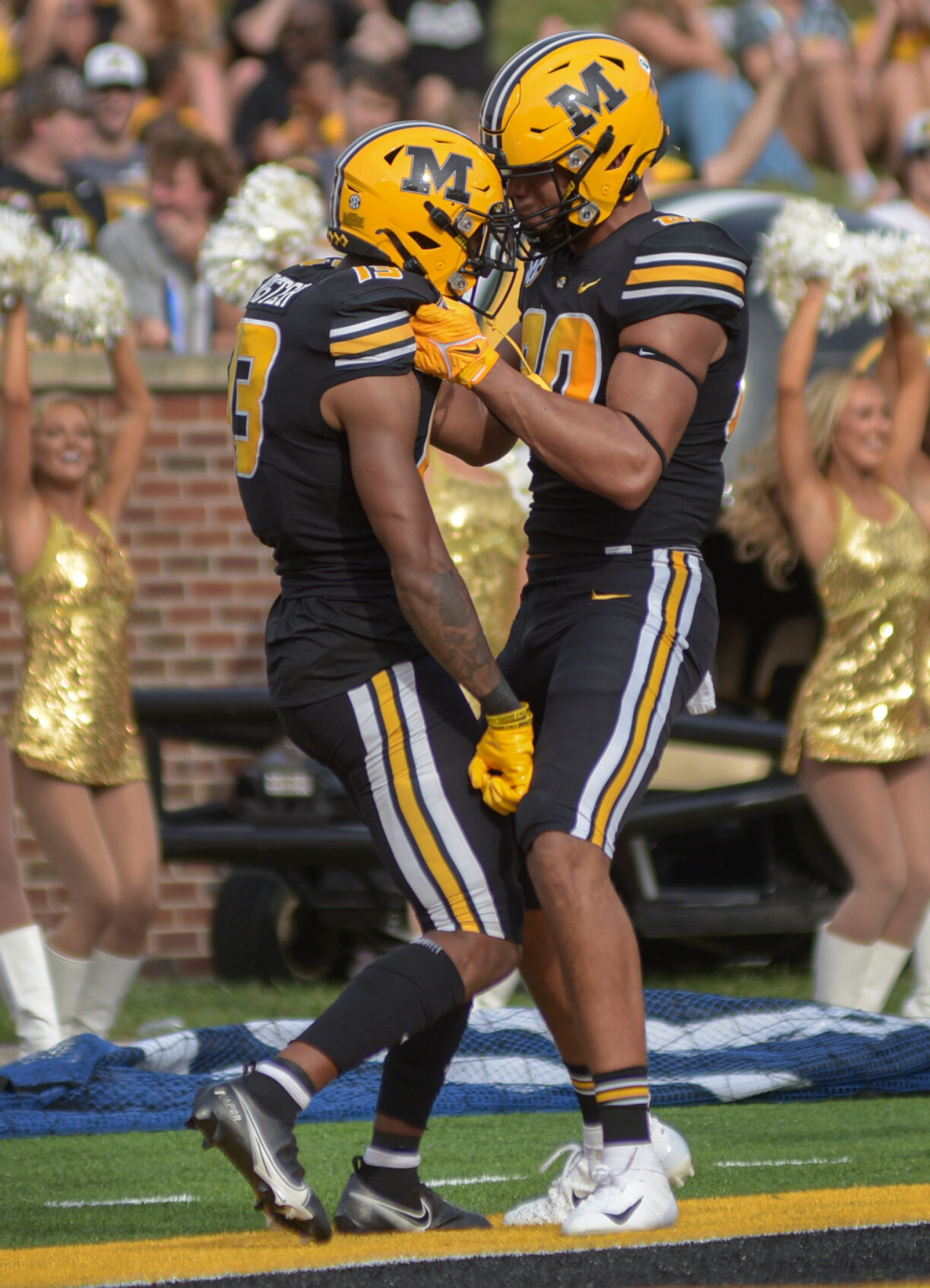 JJ Hester, left and Messiah Whiteside celebrate after a touchdown Saturday at the Faurot Field at Memorial Stadium.
